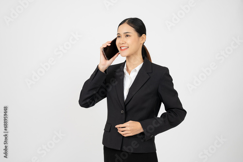 Confident Asian businesswoman using smartphone, having a phone call on white isolated background.