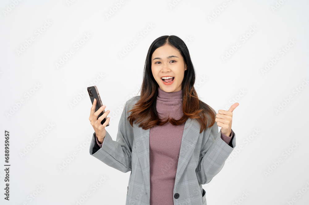 Happy Young Asian businesswoman holding smartphone, white isolated background. Happy Young Asian businesswoman holding smartphone, white isolated background.