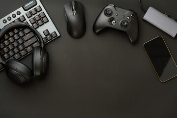 Gaming concept on black background with computer keyboard and joystick