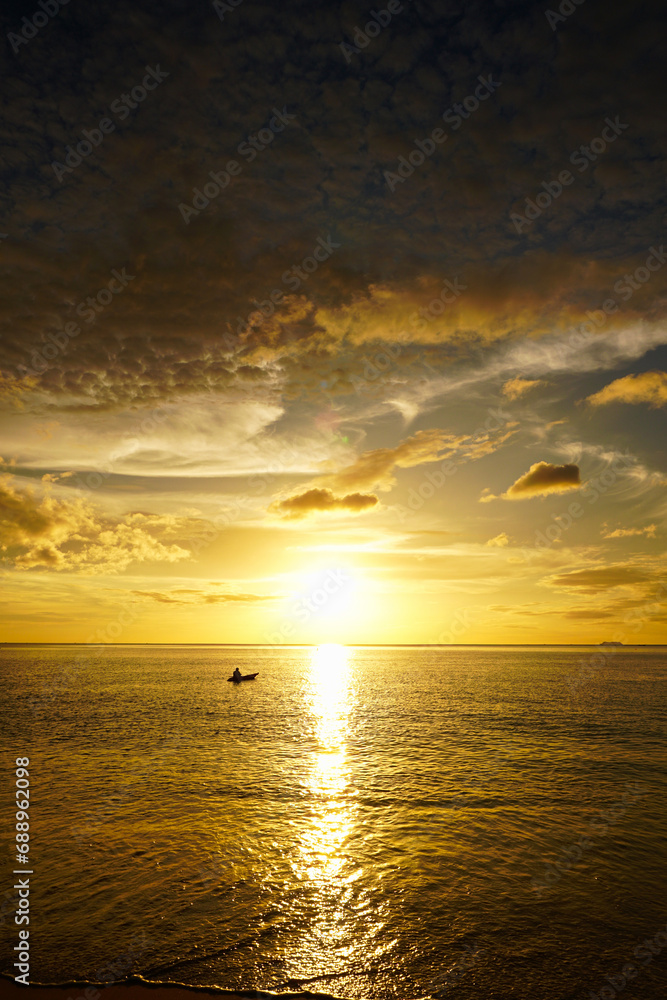 Fototapeta premium Scenic destination. A Kayak in a amazing golden sunset and clouds over the ocean. From a tropical island in the south of Thailand.