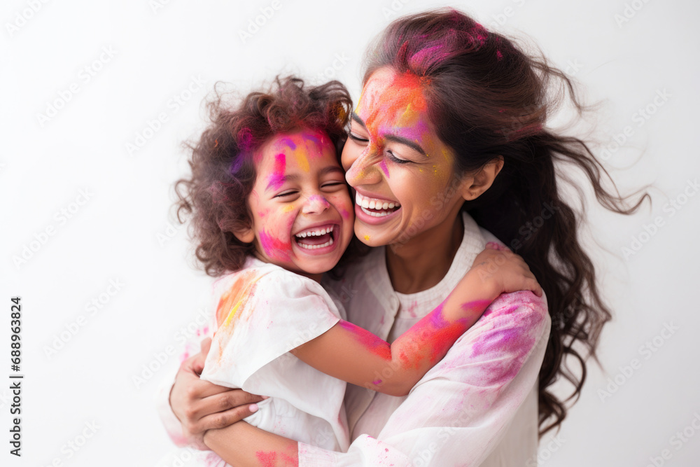 Obraz premium Indian ethnic mother and daughter having fun by celebrating Holi festival with colours 