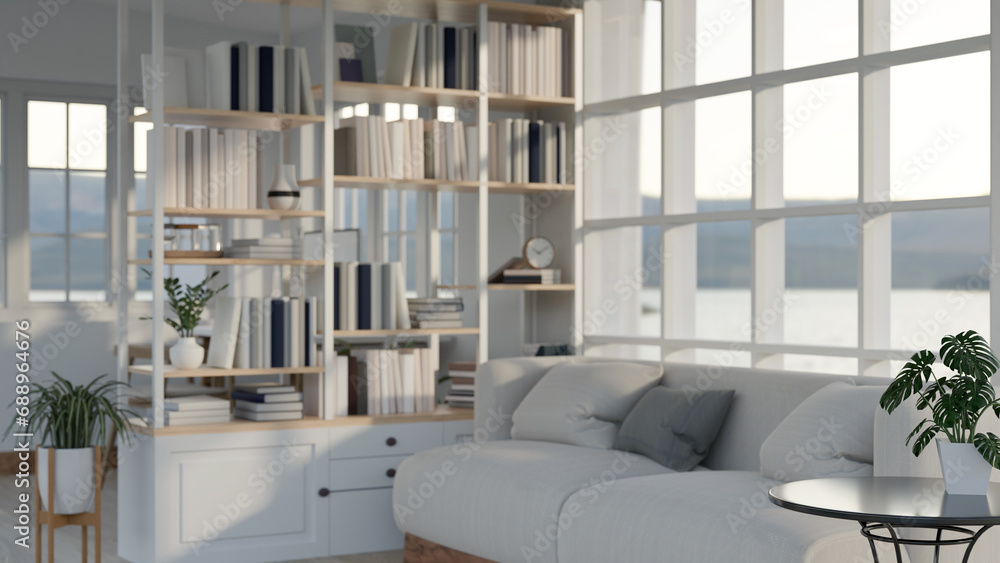 Image of cozy white modern living room with sofa and bookshelf with large window.
