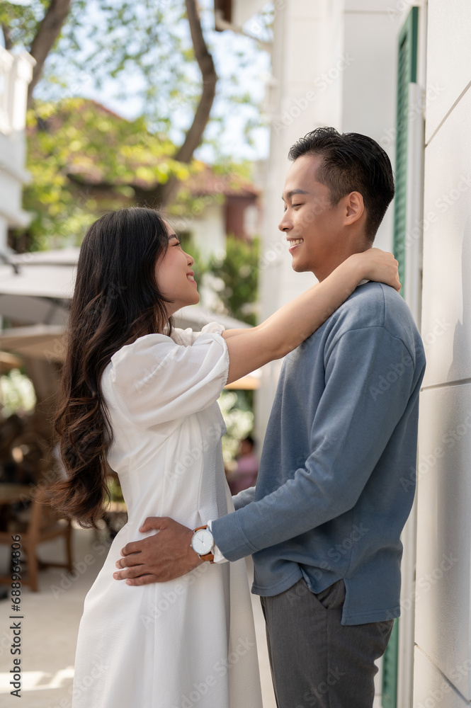 Young lovely adorable Asian couple spending time together, hugging and holding and holding hand. Young lovely adorable Asian couple spending time together, hugging and holding and holding hand.