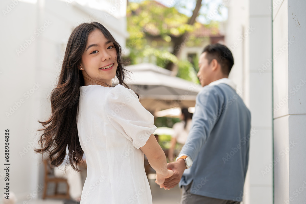 Young lovely adorable Asian couple spending time together, hugging and holding and holding hand. Young lovely adorable Asian couple spending time together, hugging and holding and holding hand.