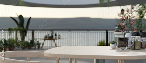 Close-up image of an empty space on a wooden table on a beautiful spacious balcony with garden.