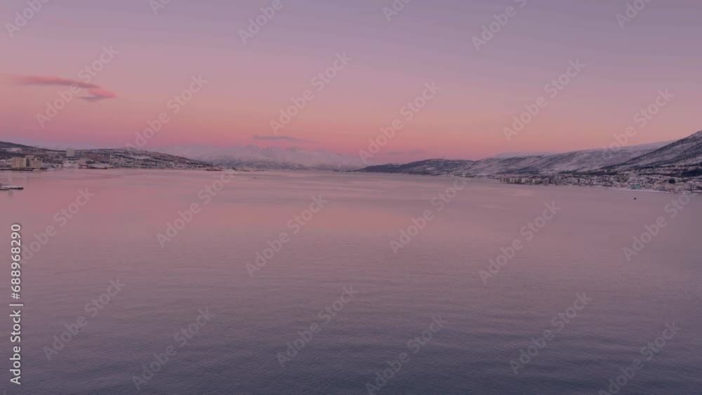 View of the Norwegian sea from Tromso Norway, calm waters and snow covered mountains in the distance View of the Norwegian sea from Tromso Norway, calm waters and snow covered mountains in the distance