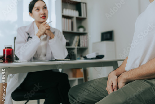 A doctor is counseling a young male patient about prostate cancer and venereal disease, including male sexual dysfunction. Prostate cancer concept