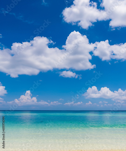 White clouds with blue sky over calm sea beach in tropical sland
