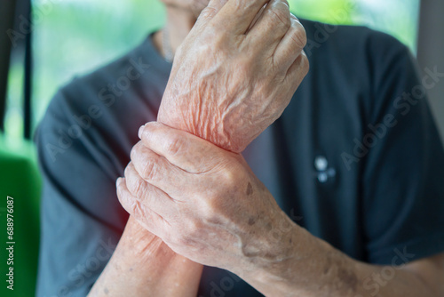 Elderly male patient suffer from numbing pain in hand, numbness fingertip, arthritis inflammation photo