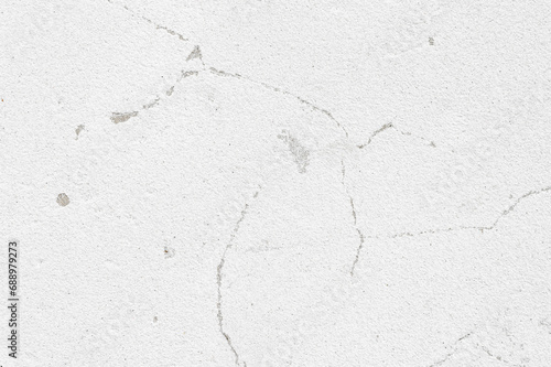 An old wall with a cracked texture is decorated with cement mortar