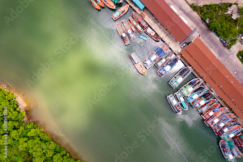 High angle view fisherman boats at the jetty located in Phuket Thailand, aerial view drone top down view,Siray fishing port Phuket Thailand photo