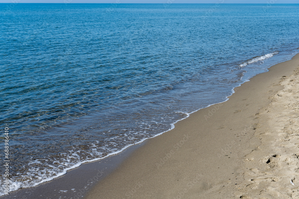 sand, foam and water at Collelungo beach on Mediterranean shore, near Marina di Alberese, Italy