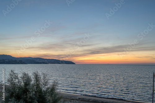 sunset at Argentario promontory on Mediterranean shore, near Giannella, Orbetello, Italy photo