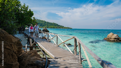 A couple of men and woman at Ko Kham tropical Island Sattahip Chonburi Samaesan Thailand