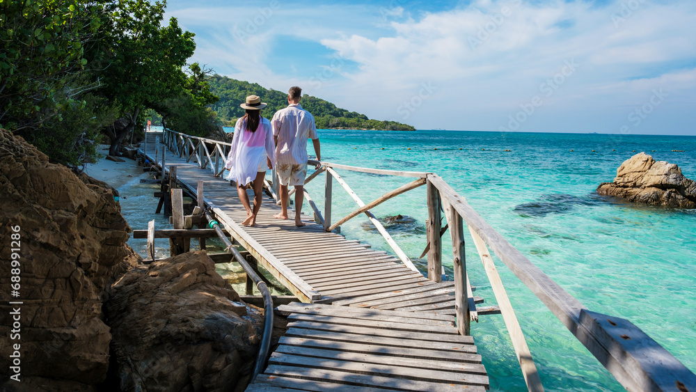 A couple of men and woman at Ko Kham tropical Island Sattahip Chonburi Samaesan Thailand A couple of men and woman at Ko Kham tropical Island Sattahip Chonburi Samaesan Thailand