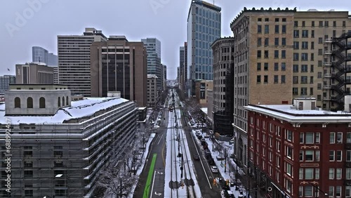 Salt Lake City skyline on winter's day, TRAX light rail system in transit. Drone photo