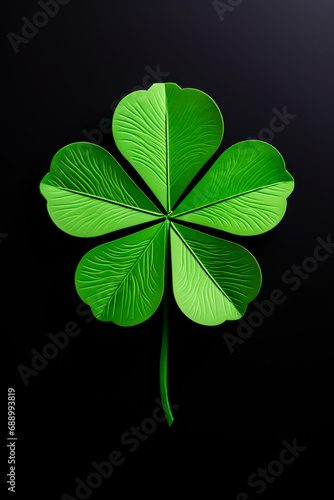 Four leaf clover is shown in the dark background, with black background.