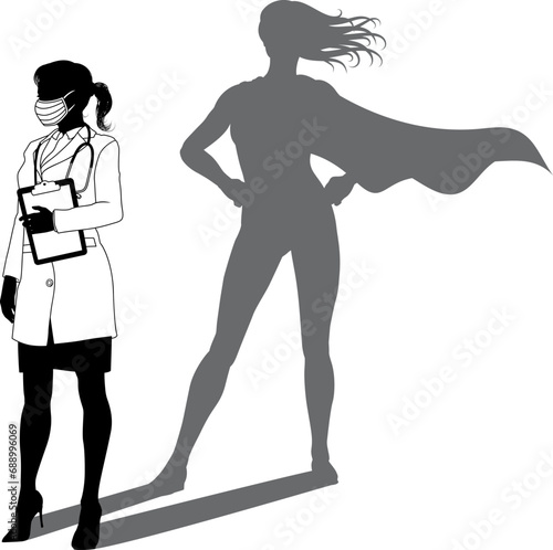 A superhero medical doctor woman health care worker revealed by her shadow silhouette as a super hero in a cape.
