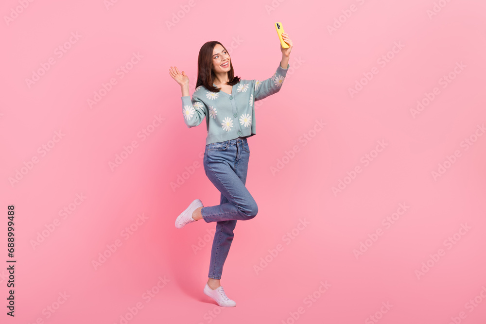 Full length photo of cute excited woman dressed teal outfit video call modern gadget waving hi arm isolated pink color background