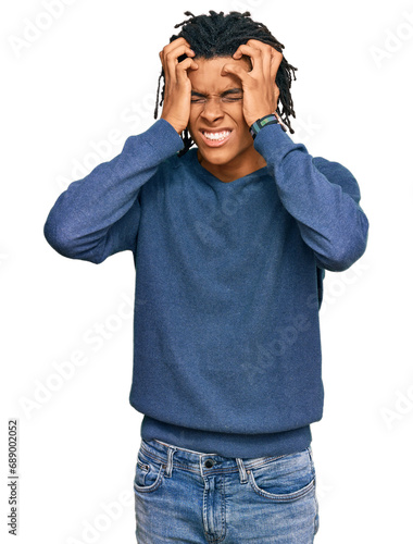Young african american man wearing casual winter sweater suffering from headache desperate and stressed because pain and migraine. hands on head.