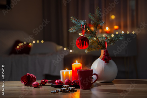hot drink in red cup with christmas decorations at home
