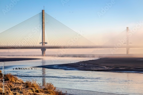 Cable-Stayed River Crossing Mersey Gateway Bridge in winter with fog
