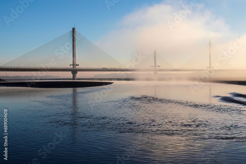 Cable-Stayed River Crossing Mersey Gateway Bridge in winter with fog