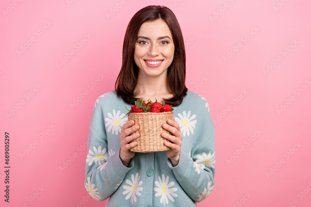Photo of shiny cute lady wear turquoise clothes smiling holding strawberry basket isolated pink color background Photo of shiny cute lady wear turquoise clothes smiling holding strawberry basket isolated pink color background