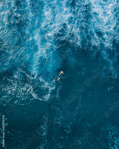 aerial view of a surfer in the ocean