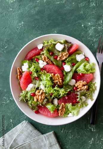 Salad with grapefruit, white cheese, pomegranate and nuts. Healthy eating. Vegetarian food. Diet.