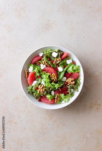 Salad with grapefruit, white cheese, pomegranate and nuts. Healthy eating. Vegetarian food. Diet.