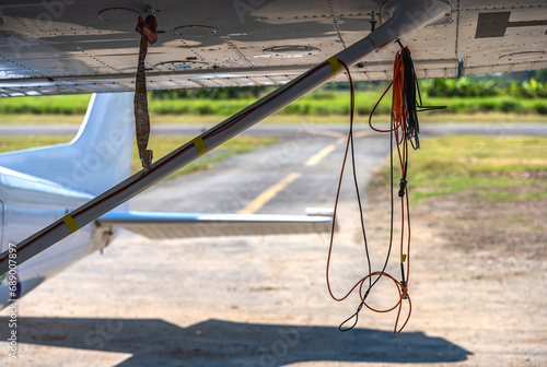 Rope hanging on small plane in airfield photo