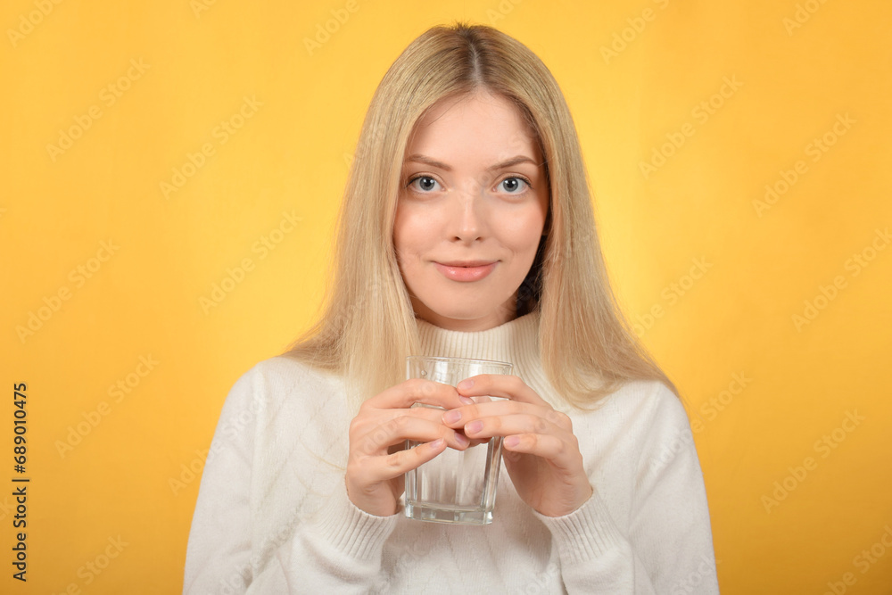 young pretty blonde woman holding a glass of water young pretty blonde woman holding a glass of water