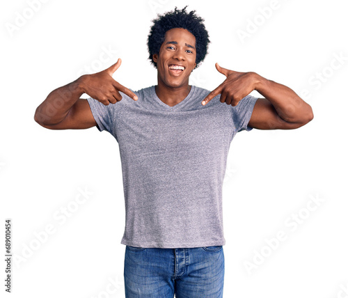 Handsome african american man with afro hair wearing casual clothes looking confident with smile on face, pointing oneself with fingers proud and happy.
