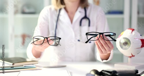 Wallpaper Mural The woman is shows a model of glasses for vision, close-up. Choosing a frame for glasses, ophthalmologist Torontodigital.ca