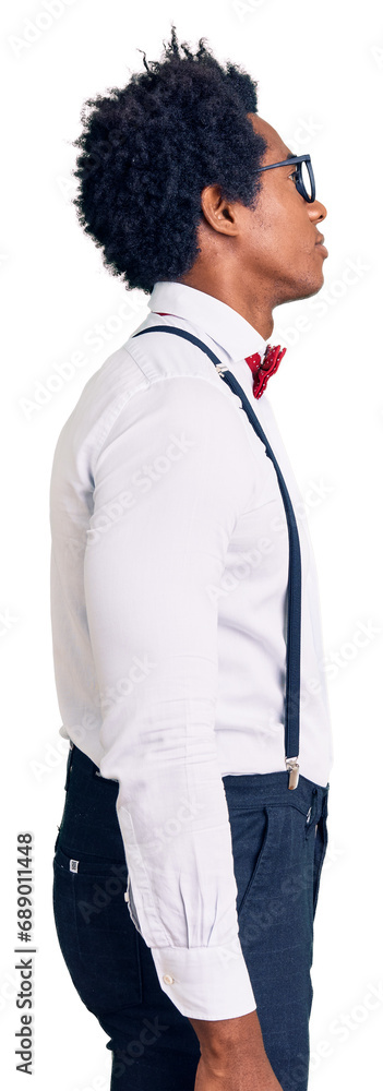 Handsome african american man with afro hair wearing hipster elegant look looking to side, relax profile pose with natural face with confident smile. Handsome african american man with afro hair wearing hipster elegant look looking to side, relax profile pose with natural face with confident smile.