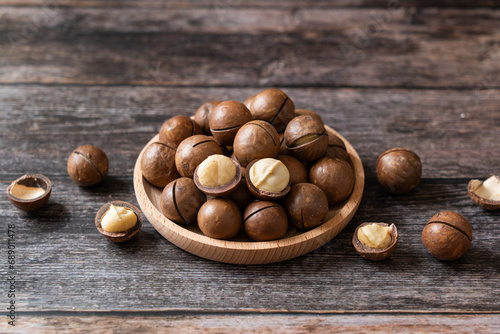 Close up macadamia nuts on wooden background.
