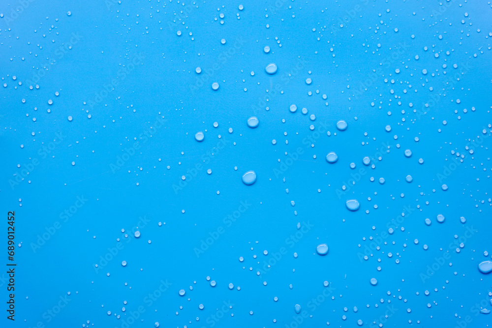 Water or rain drops on blue background 
