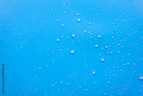 Water or rain drops on blue background 