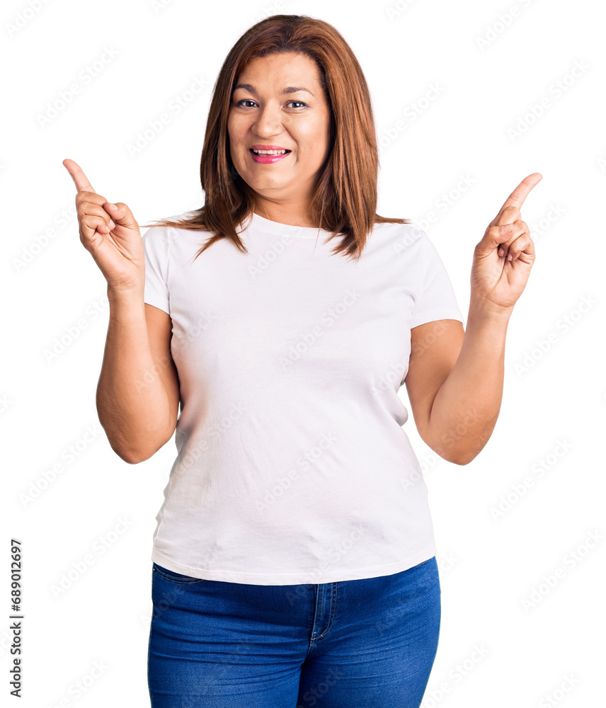 Middle age latin woman wearing casual white tshirt smiling confident pointing with fingers to different directions. copy space for advertisement