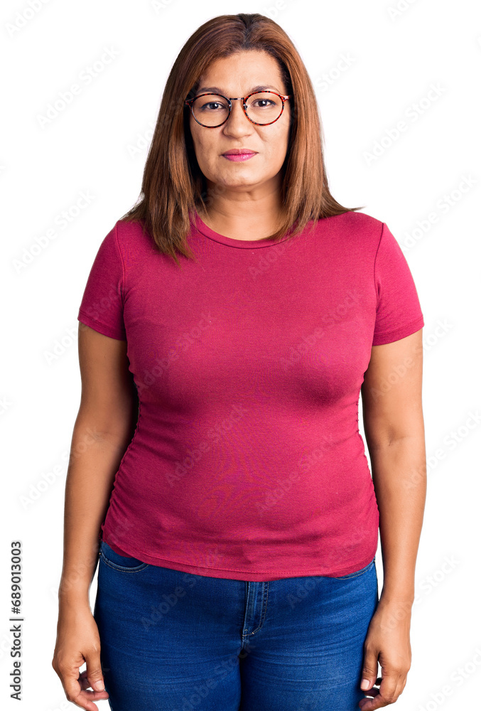 Fototapeta premium Middle age latin woman wearing casual clothes and glasses with serious expression on face. simple and natural looking at the camera.