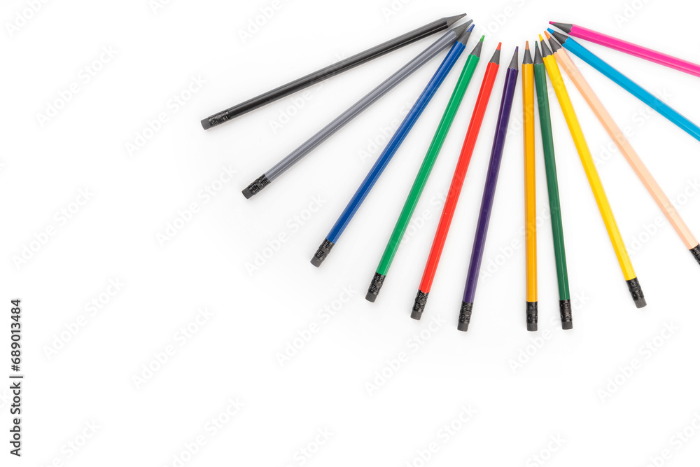 Wooden color pencils arranged in row on white isolated background. Selective focus