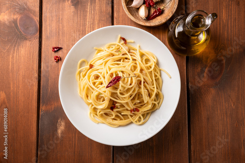 Piatto di tipici spaghetti conditi con aglio, olio e peperoncino, cibo italiano  photo