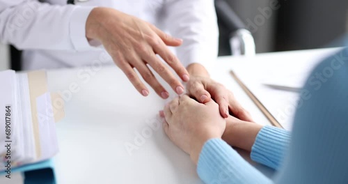 Doctor holding patient hands and soothing 4k movie slow motion. Psychological assistance to patients with incurable diseases concept photo