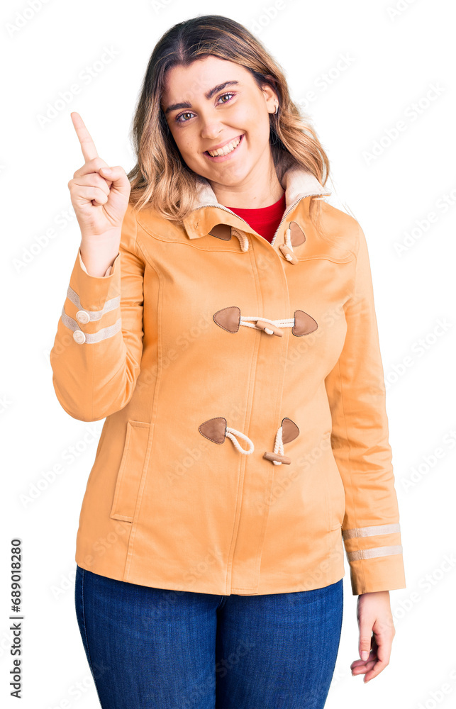Young caucasian woman wearing casual clothes pointing finger up with successful idea. exited and happy. number one. Young caucasian woman wearing casual clothes pointing finger up with successful idea. exited and happy. number one.