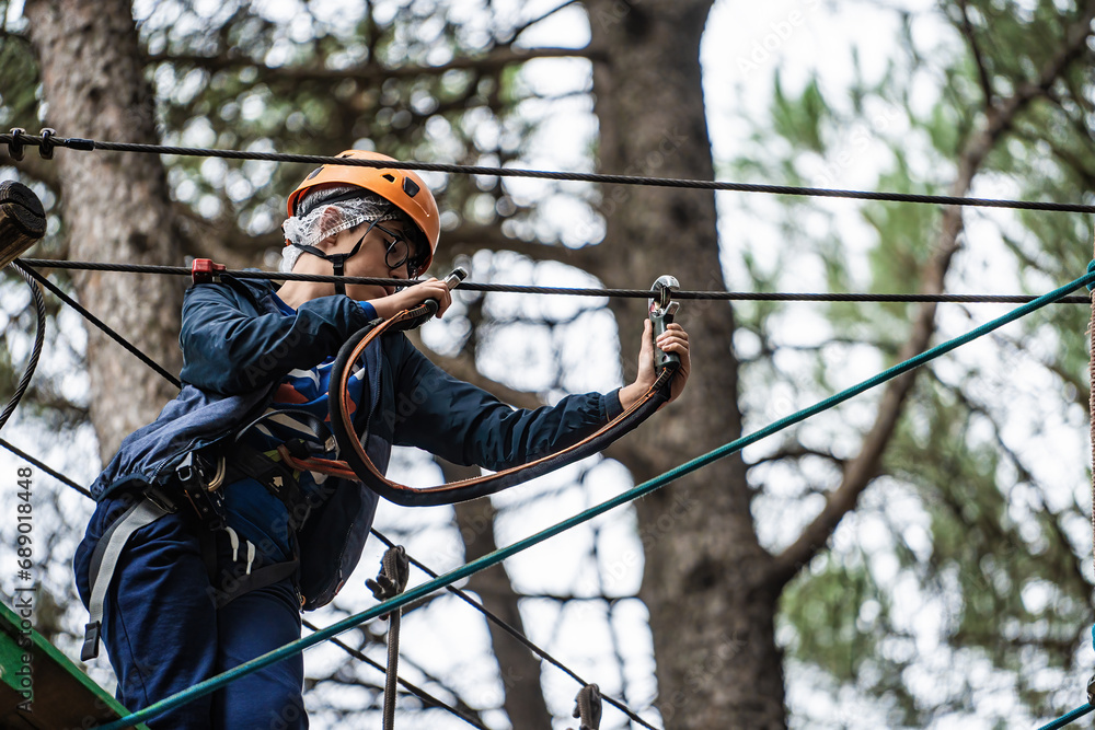 Little Boy Engaged in a High Rope Adventure Course Little Boy Engaged in a High Rope Adventure Course