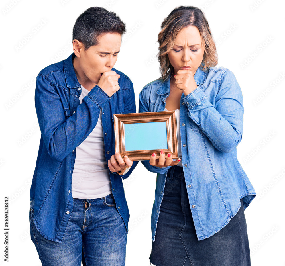 Couple of women holding empty frame feeling unwell and coughing as symptom for cold or bronchitis. health care concept. Couple of women holding empty frame feeling unwell and coughing as symptom for cold or bronchitis. health care concept.