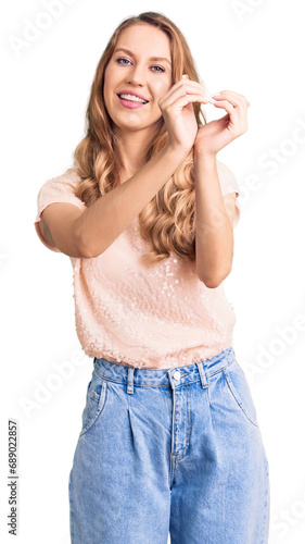 Young beautiful caucasian woman with blond hair wearing casual clothes smiling in love doing heart symbol shape with hands. romantic concept.