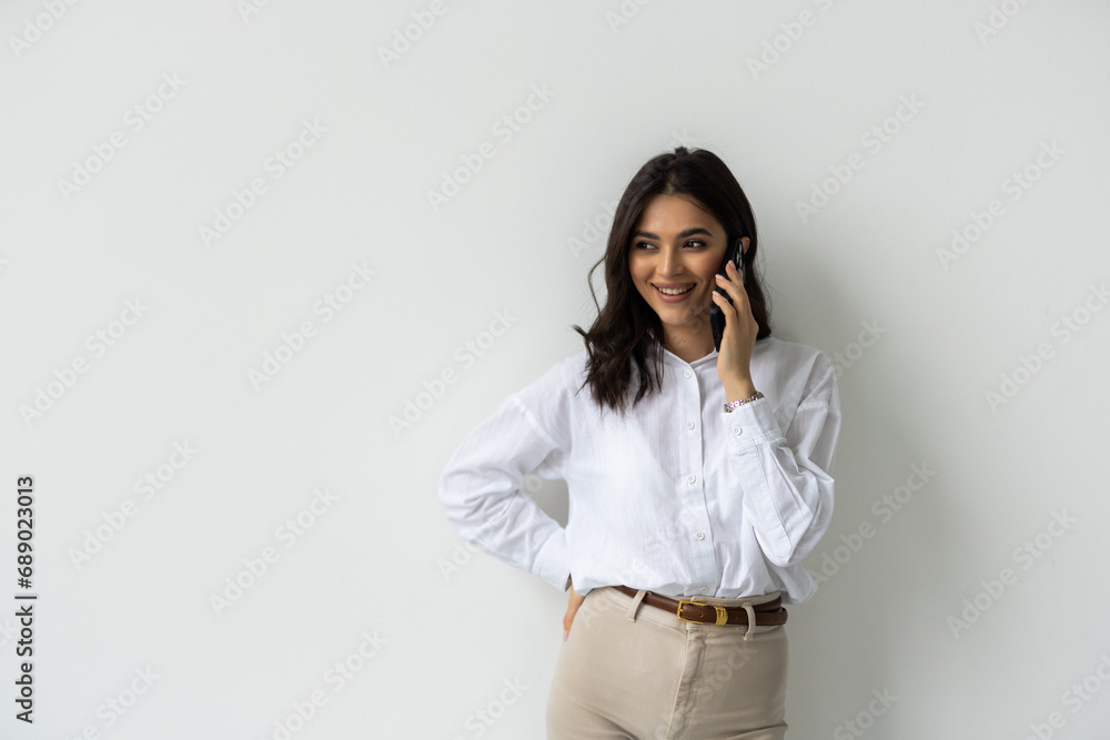 Portrait of a young business woman talking on mobile phone isolated over white background Portrait of a young business woman talking on mobile phone isolated over white background