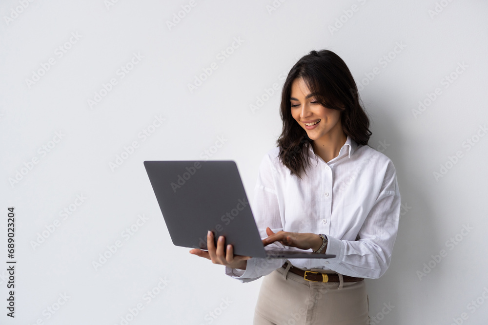 Portrait of a happy businesswoman working on laptop isolated over white background Portrait of a happy businesswoman working on laptop isolated over white background
